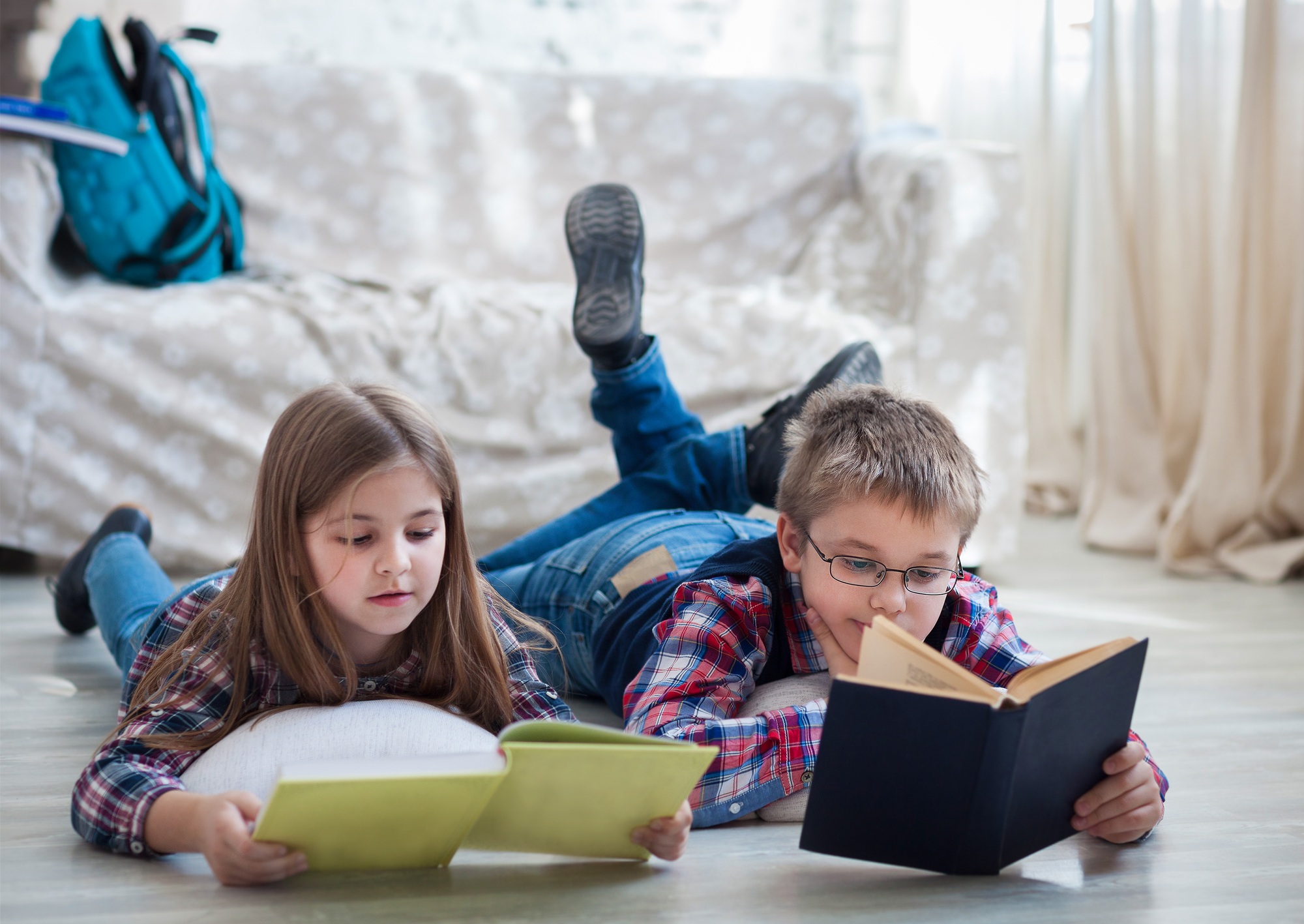 Children readind book in living room