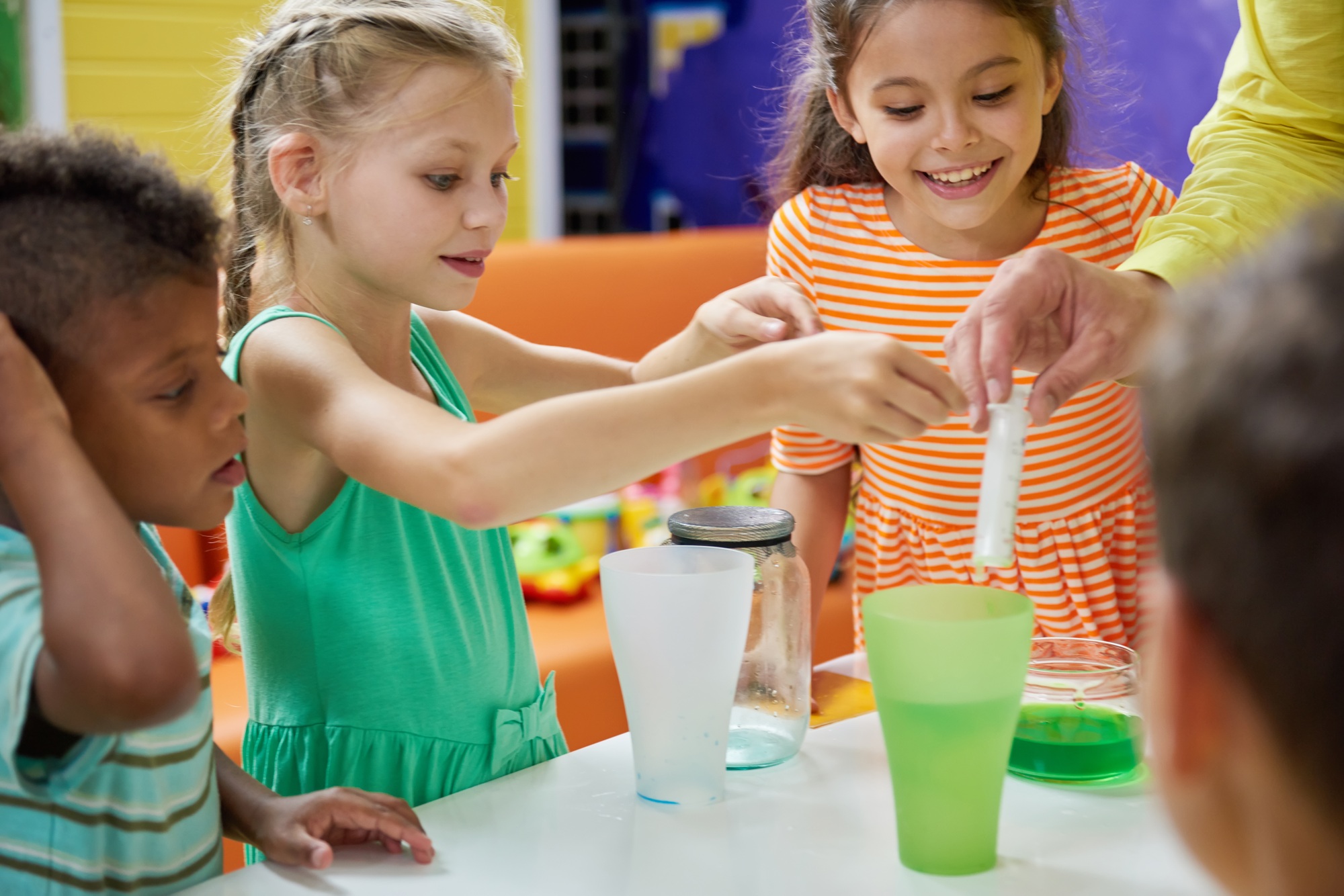 Kids doing chemical experiment at entertainment center.